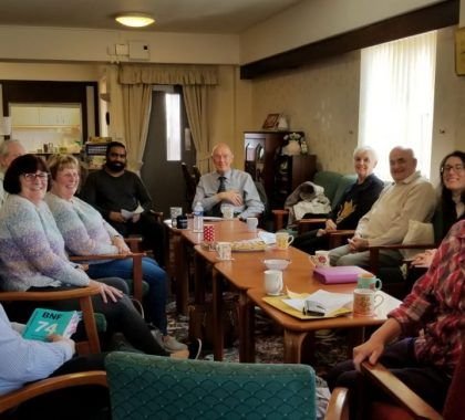 Employees at Orford Pharmacy sitting with patients