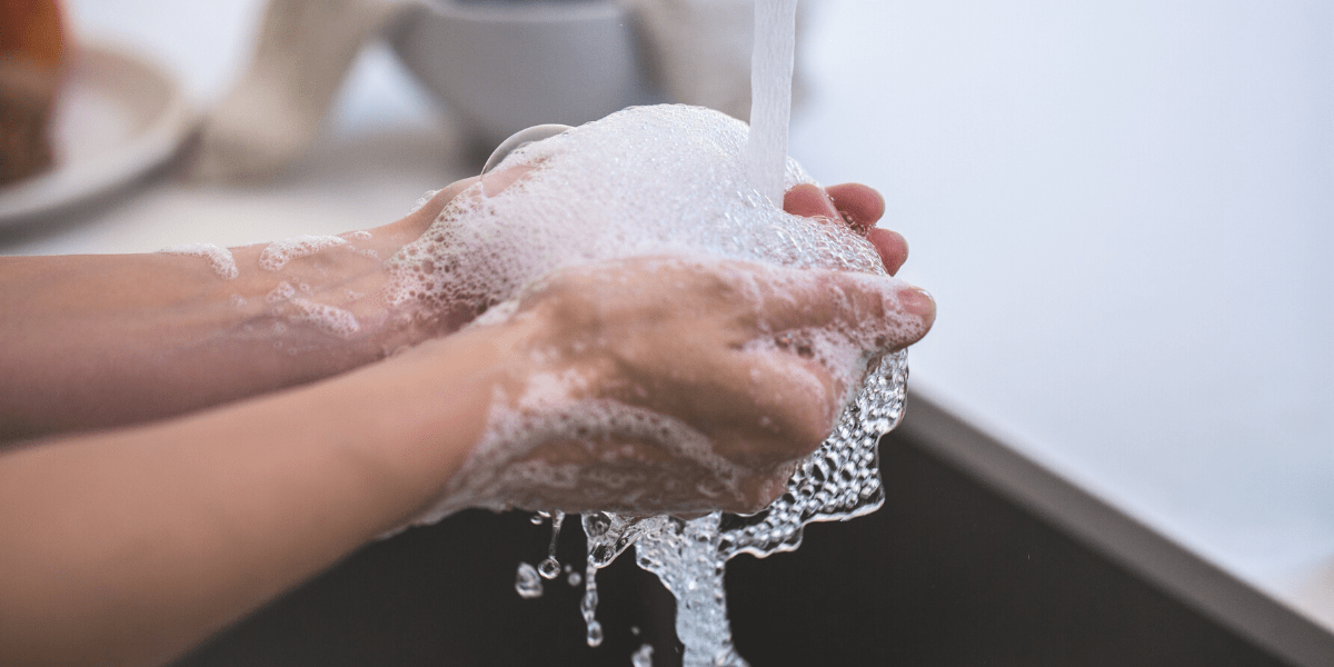 Soapy hands being washed