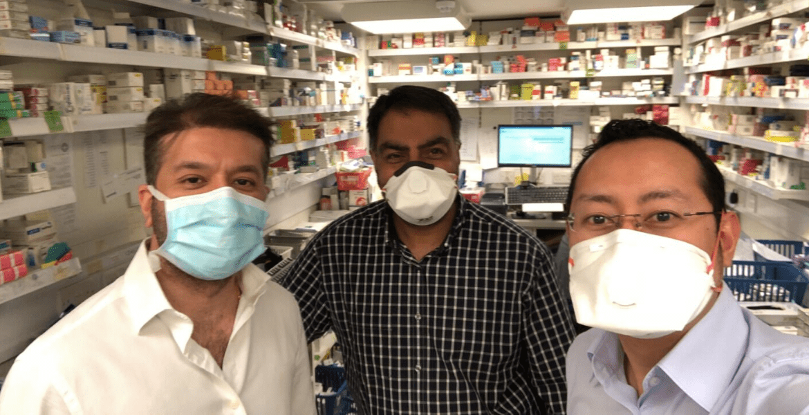 Three masked pharmacists