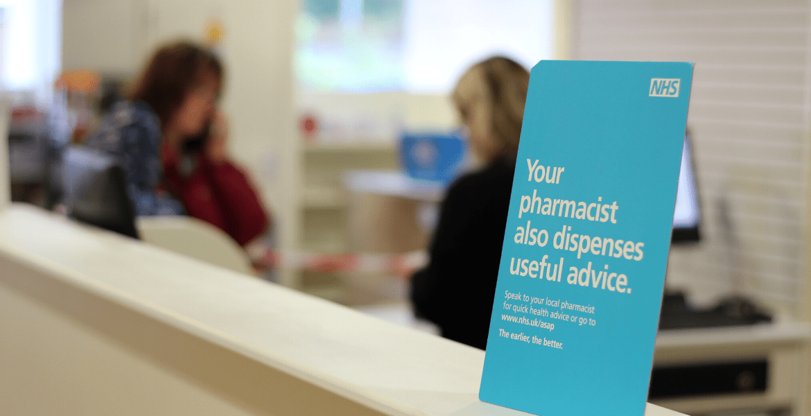 Promotional NHS sign on a pharmacy counter