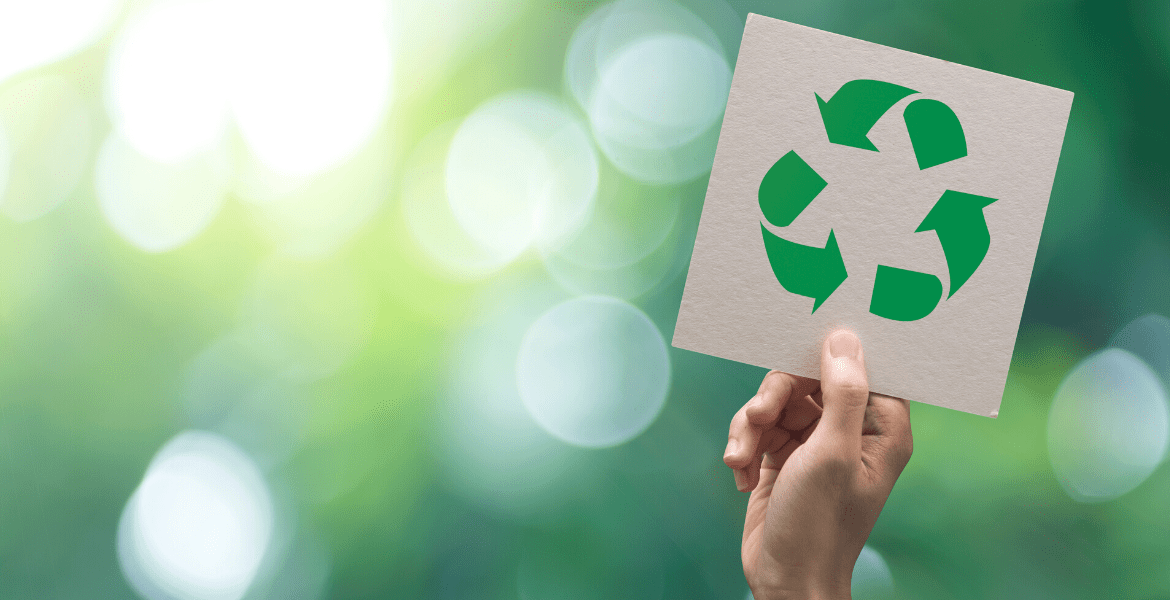 Hand holding a Recycle sign