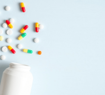 Pill bottles lying on side with pills scattered beside them