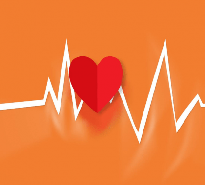 Vector heart and heart rate line against orange background