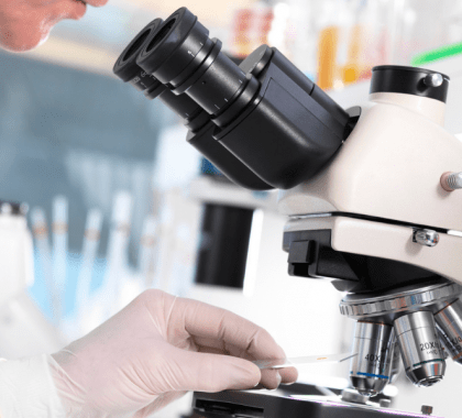 Person placing slide under microscope