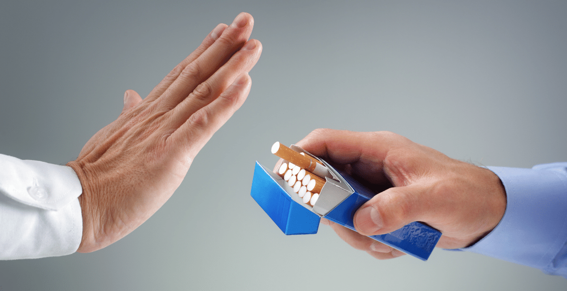 Person rejecting packet of cigarettes