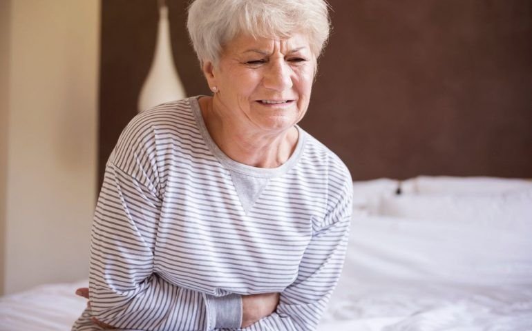 Old woman clutching bowels