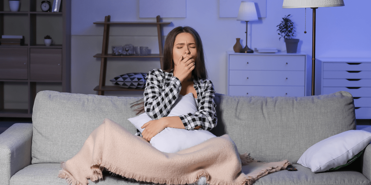 Person yawning on couch
