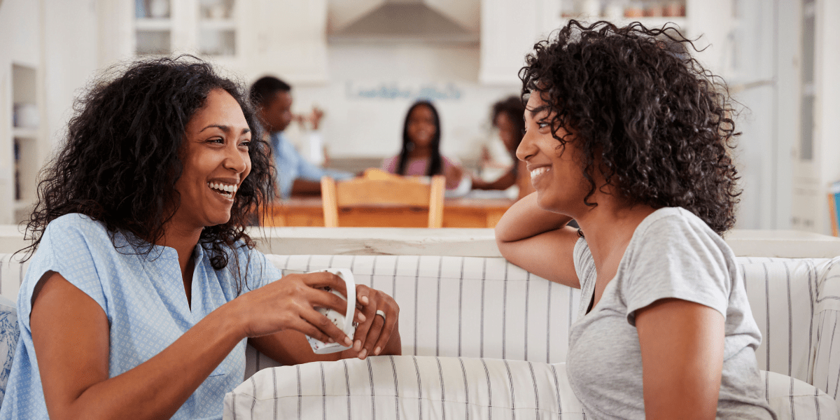 two people talking on a sofa