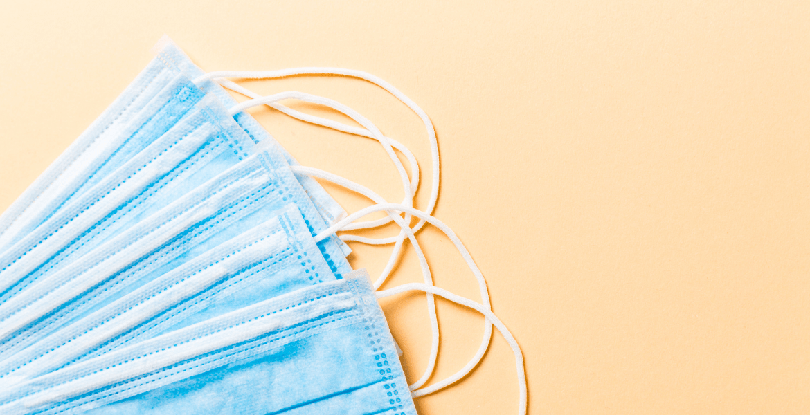 Blue face masks across a yellow background