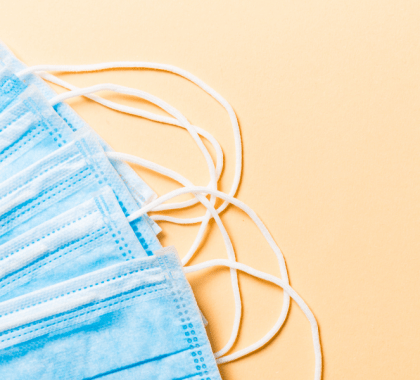 Blue face masks across a yellow background