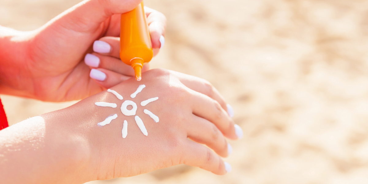 sun cream on hand in shape of sun
