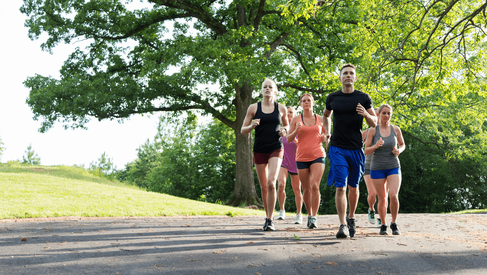 A group of people jogging outside